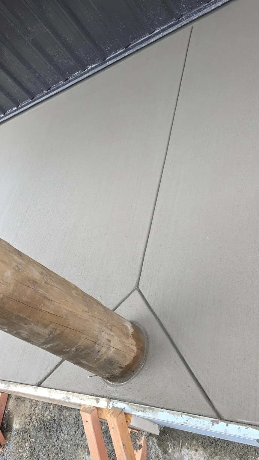 Broom finished concrete poured neatly around a timber verandah post