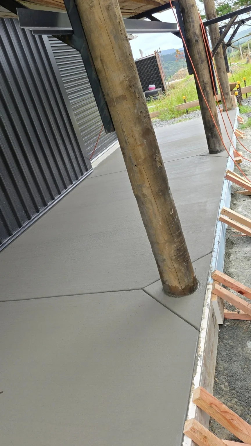 Broom finished concrete walkway worked around timber posts