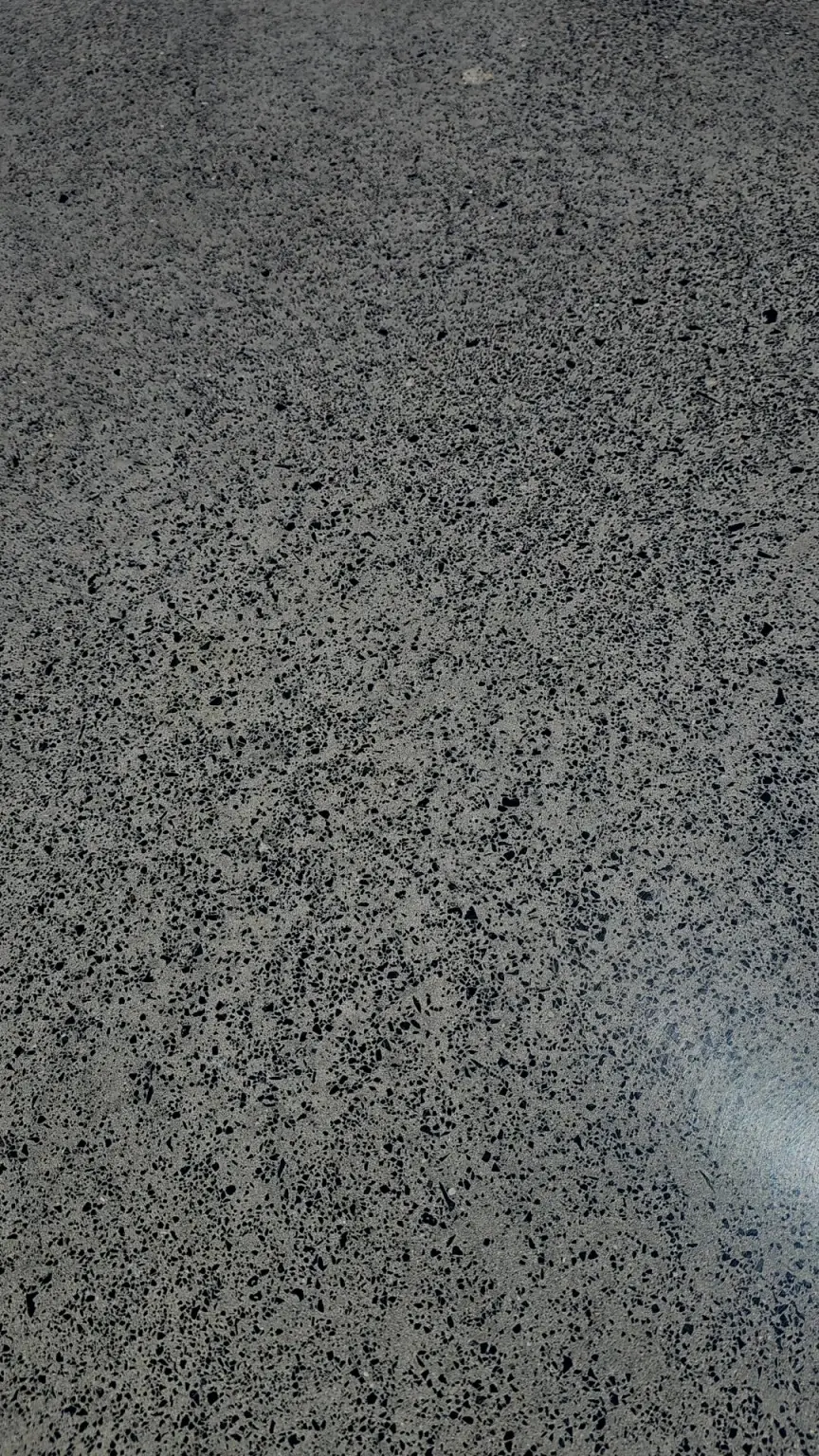 Medium aggregate exposure: more stone revealed across a salt-and-pepper polished surface