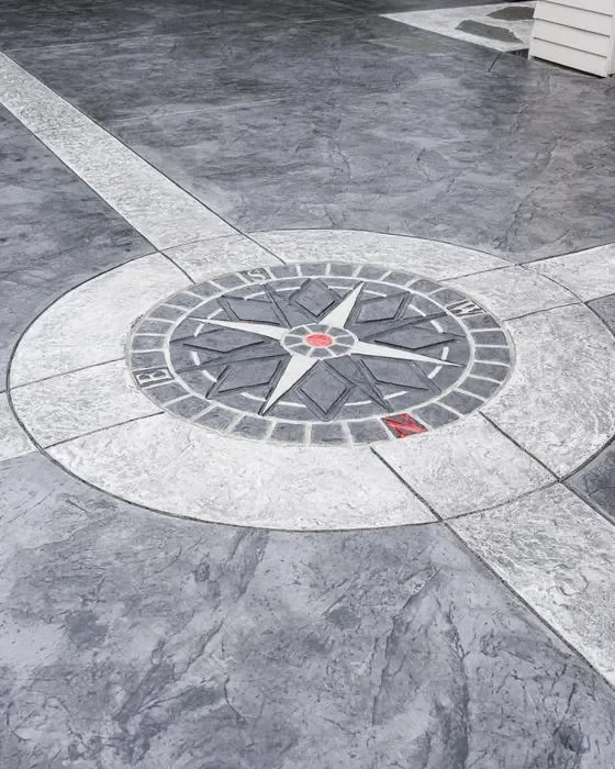 Stamped concrete compass rose medallion with cross banding set into a driveway