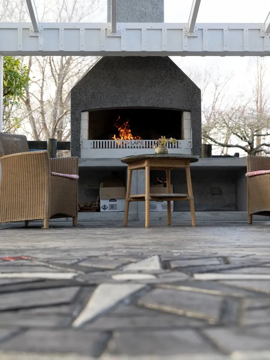 Outdoor fireplace and lounge setting on a crazy-pave natural stone patio