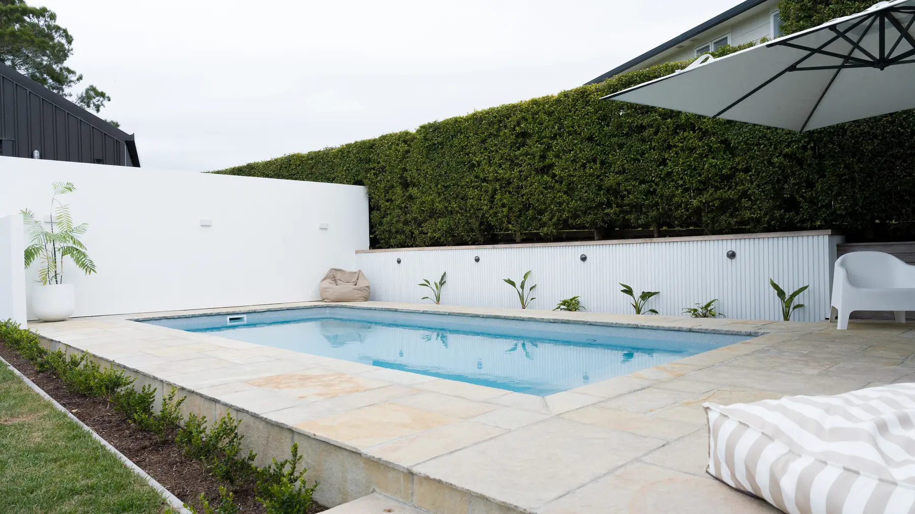 Antique Shahabad limestone pool surround with chiselled coping in Manly, Whangaparaoa