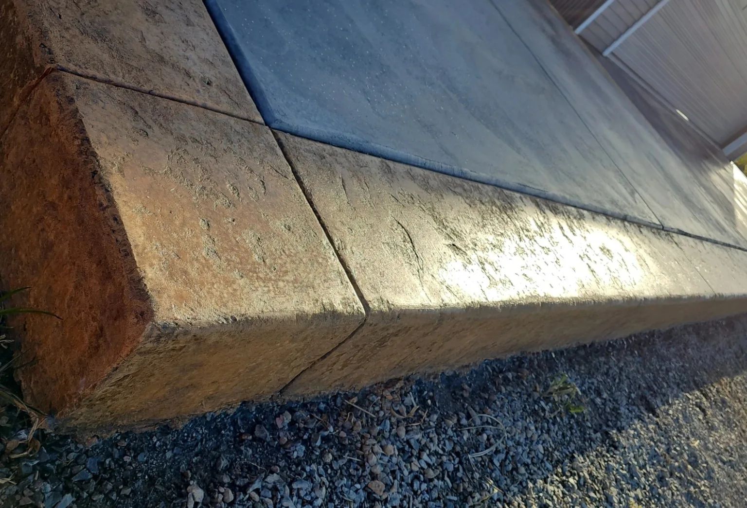 Stamped concrete border edge, antiqued and sealed, with a crisp mitred corner